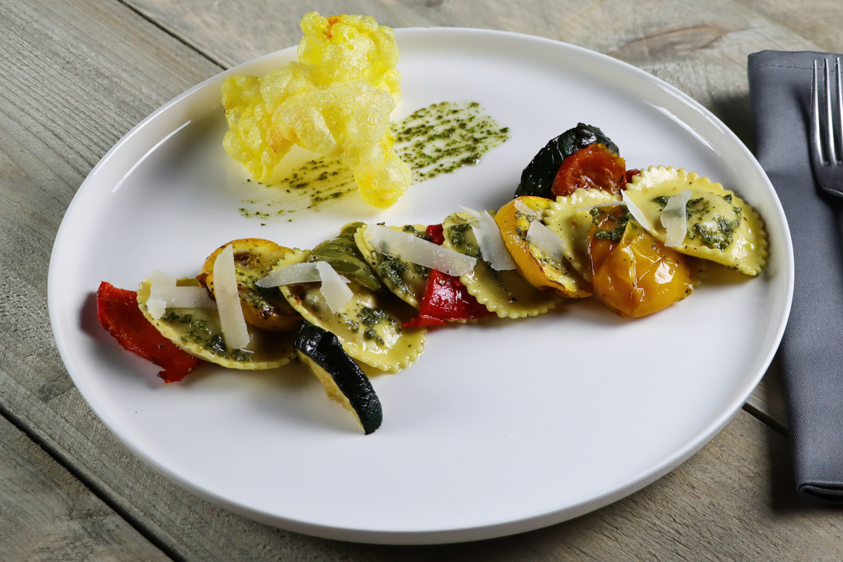 Tortelli Tomato & Mozzarella, with grilled vegetables with pesto verde and garnished with parmesan crackers